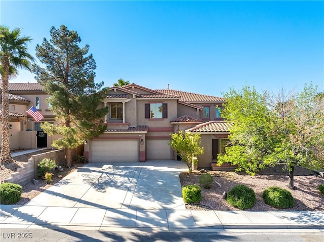 853 Ashford Way, Henderson, NV 89015 - mediterranean / spanish-style house featuring a garage, driveway, stucco siding, and a tile roof