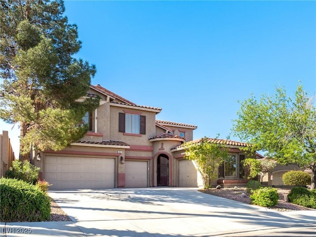 853 Ashford Way, Henderson, NV 89015 - mediterranean / spanish house featuring a tiled roof, a garage, stucco siding, and driveway