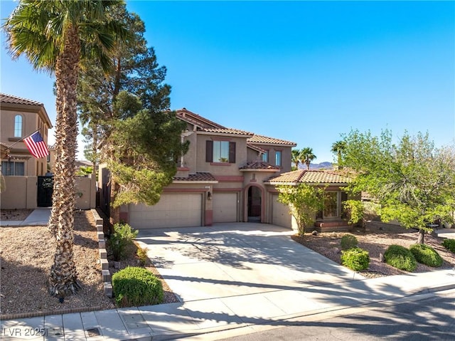853 Ashford Way, Henderson, NV 89015 - mediterranean / spanish-style home featuring a tiled roof, an attached garage, fence, stucco siding, and driveway