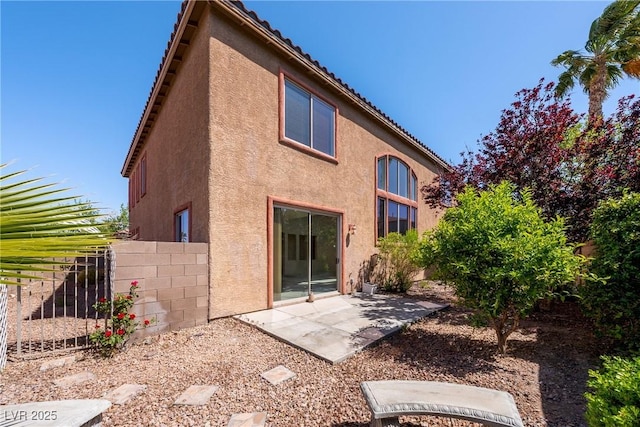 853 Ashford Way, Henderson, NV 89015 - back of property featuring a patio area, a tiled roof, fence, and stucco siding