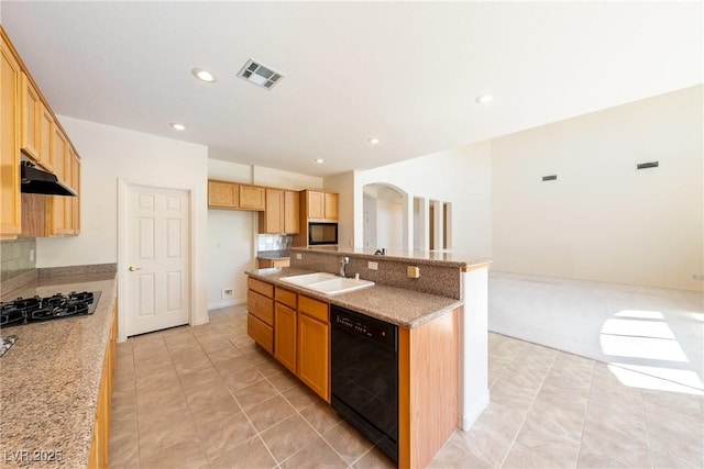 853 Ashford Way, Henderson, NV 89015 - kitchen featuring visible vents, a sink, an island with sink, under cabinet range hood, and black appliances