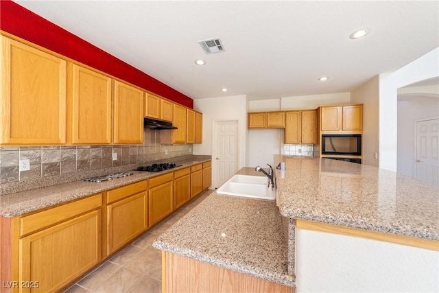 853 Ashford Way, Henderson, NV 89015 - kitchen with a sink, visible vents, backsplash, and black appliances