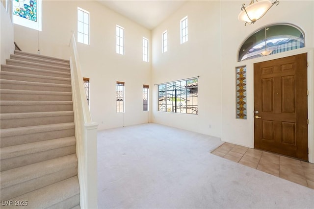 853 Ashford Way, Henderson, NV 89015 - entrance foyer featuring carpet flooring, a high ceiling, and stairs