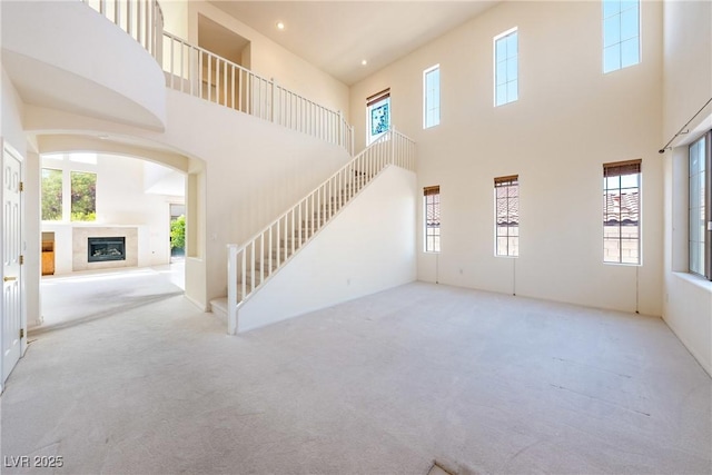 853 Ashford Way, Henderson, NV 89015 - unfurnished living room with carpet, a towering ceiling, and a healthy amount of sunlight