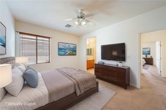 853 Ashford Way, Henderson, NV 89015 - bedroom featuring visible vents, baseboards, ensuite bathroom, a ceiling fan, and light carpet
