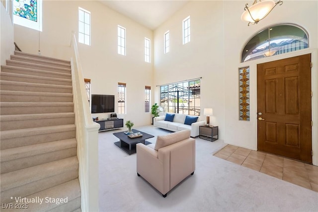 853 Ashford Way, Henderson, NV 89015 - living room with a high ceiling, a healthy amount of sunlight, carpet, and stairs