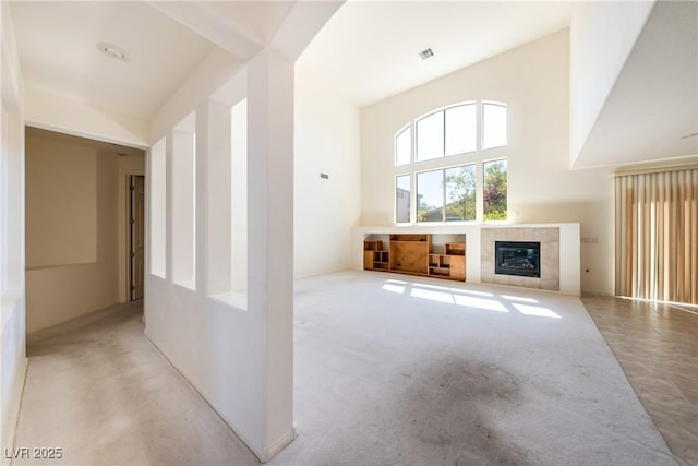 853 Ashford Way, Henderson, NV 89015 - unfurnished living room featuring a fireplace, a towering ceiling, and visible vents