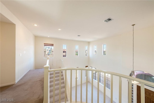 853 Ashford Way, Henderson, NV 89015 - corridor with visible vents, a wealth of natural light, an upstairs landing, and light carpet