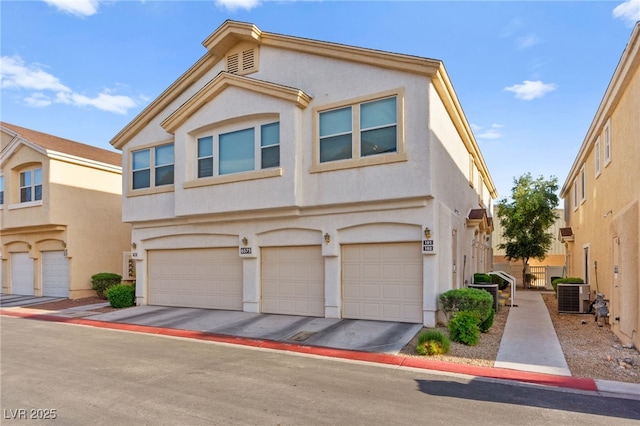 6575 Buster Brown Ave Unit 102, Las Vegas, NV 89122 - multi unit property with cooling unit, a garage, and stucco siding