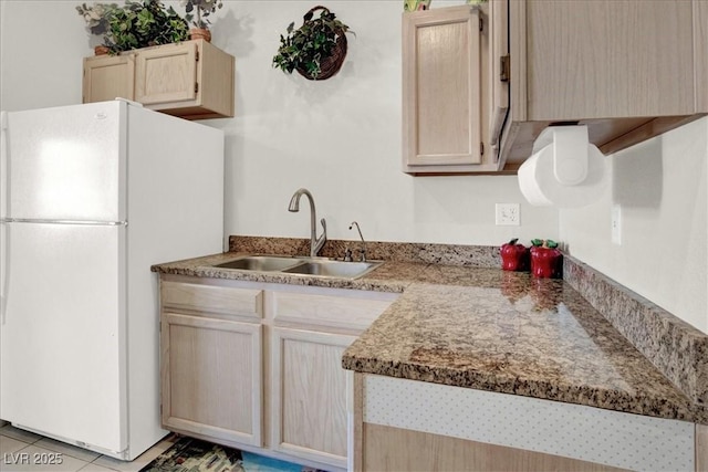 6480 Annie Oakley Dr Unit 511, Las Vegas, NV 89120 - kitchen with a sink, light tile patterned floors, freestanding refrigerator, and light brown cabinets