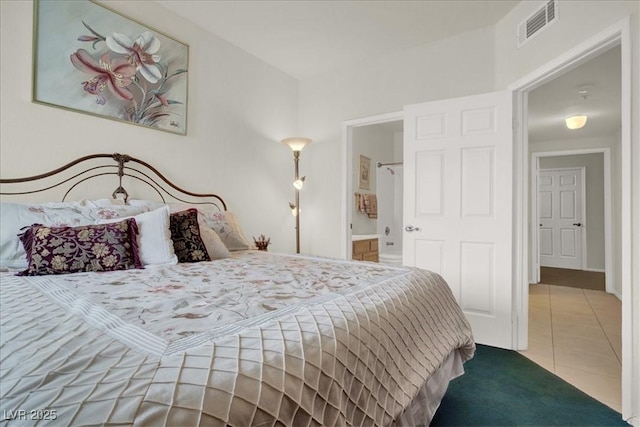6480 Annie Oakley Dr Unit 511, Las Vegas, NV 89120 - bedroom with visible vents, tile patterned floors, and ensuite bathroom