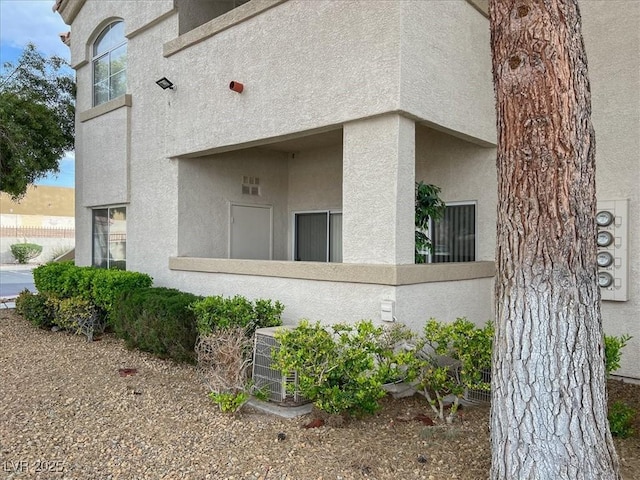 6480 Annie Oakley Dr Unit 511, Las Vegas, NV 89120 - view of property exterior featuring central AC unit, fence, and stucco siding