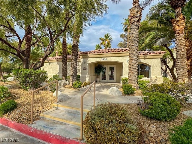 6480 Annie Oakley Dr Unit 511, Las Vegas, NV 89120 - view of front of home featuring french doors, stucco siding, and a tiled roof
