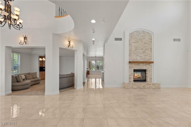 2285 Villefort Ct, Las Vegas, NV 89117 - living area with a chandelier, plenty of natural light, a high ceiling, baseboards, and a fireplace