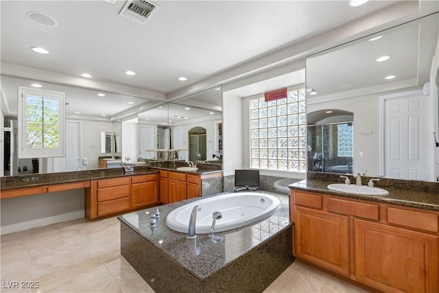 2285 Villefort Ct, Las Vegas, NV 89117 - full bath featuring a shower stall, a whirlpool tub, two vanities, and recessed lighting