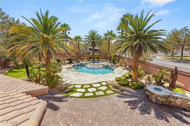 2285 Villefort Ct, Las Vegas, NV 89117 - view of pool featuring a patio area, a fenced backyard, outdoor dining space, and a pool with connected hot tub