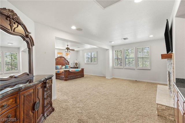 2285 Villefort Ct, Las Vegas, NV 89117 - living area with light carpet, ceiling fan, a fireplace with flush hearth, recessed lighting, and baseboards