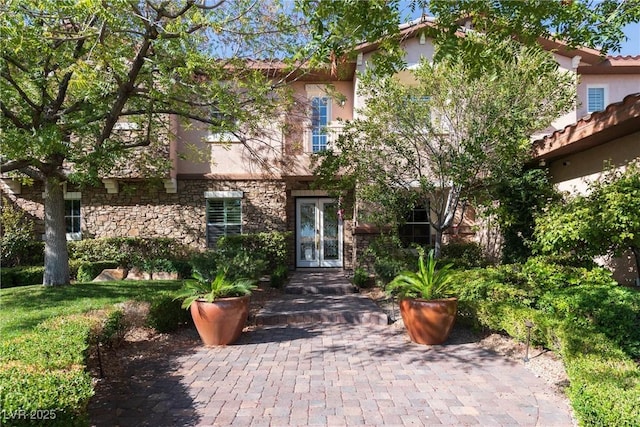 2285 Villefort Ct, Las Vegas, NV 89117 - obstructed view of property with stone siding, stucco siding, and french doors