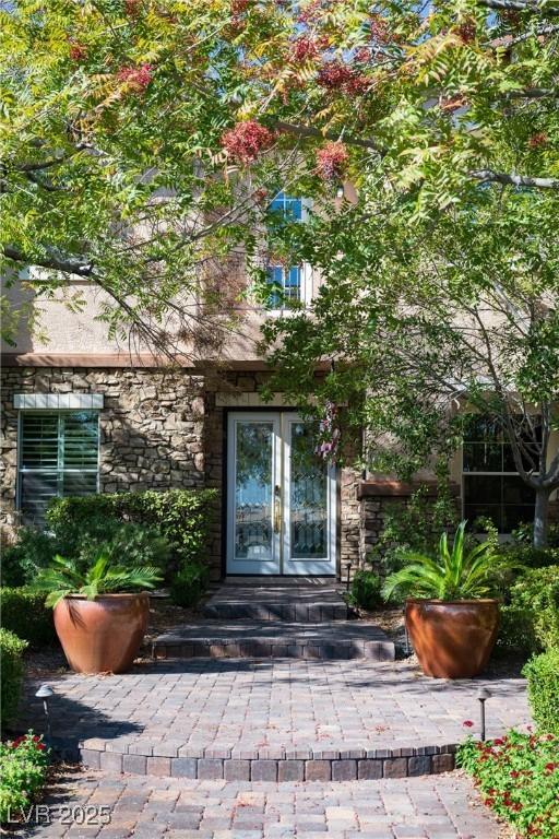 2285 Villefort Ct, Las Vegas, NV 89117 - property entrance with french doors and stone siding