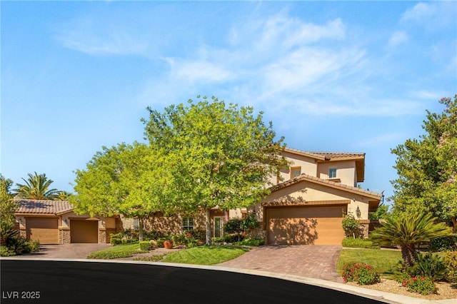 2285 Villefort Ct, Las Vegas, NV 89117 - view of front of house featuring stucco siding, a tile roof, stone siding, and a garage