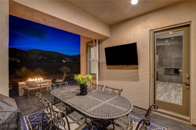 view of patio / terrace featuring outdoor dining space and a fire pit