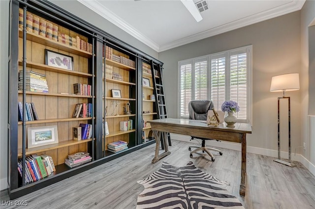 office space featuring visible vents, baseboards, crown molding, and wood finished floors