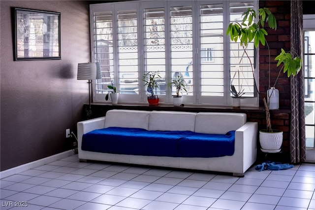 interior space featuring tile patterned floors, a wealth of natural light, and baseboards