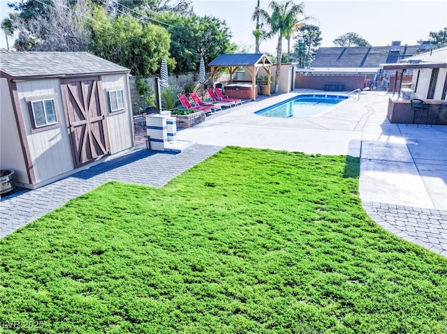 view of pool featuring a fenced backyard, an outdoor structure, a storage unit, a gazebo, and a hot tub