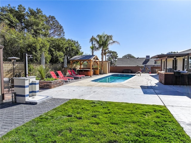 view of pool featuring a patio, a fenced backyard, outdoor dry bar, a hot tub, and a gazebo