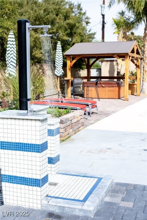 exterior space with a gazebo and a hot tub