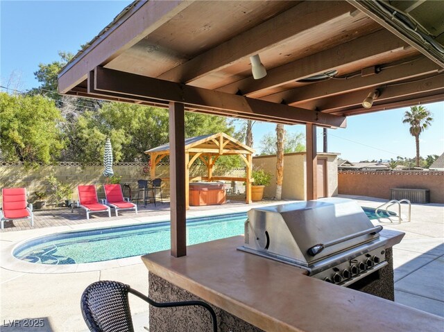 view of patio with a gazebo, a fenced backyard, a hot tub, and a fenced in pool