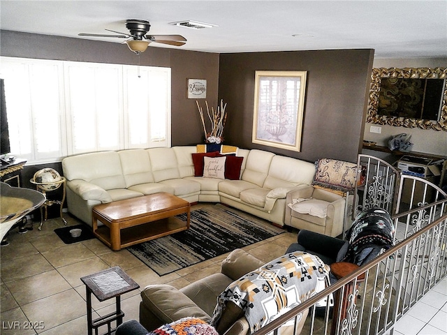 tiled living area featuring ceiling fan and visible vents