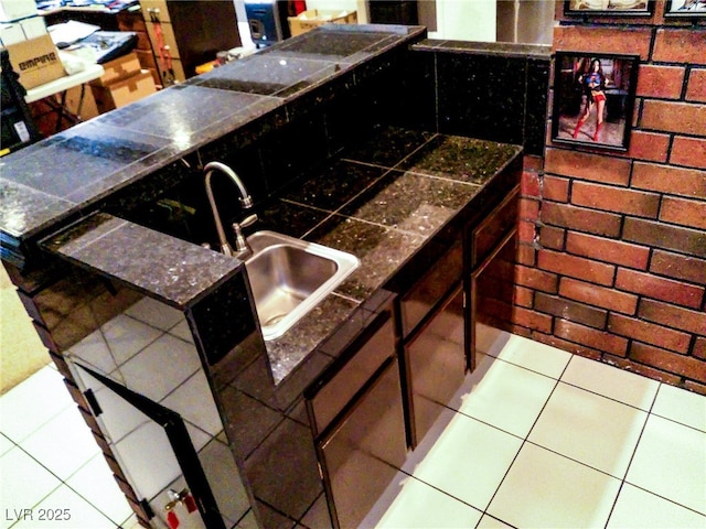 interior space featuring tile patterned floors and a sink