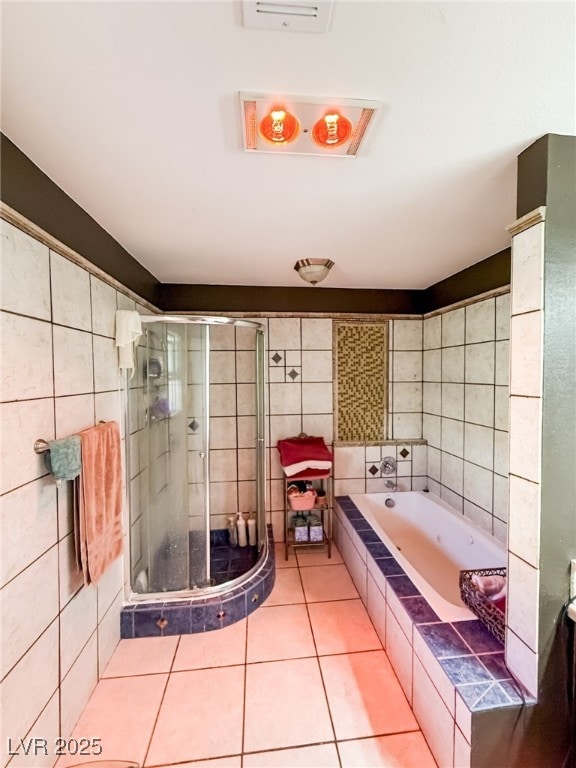 full bath with tile patterned floors, a shower stall, a bath, and tile walls