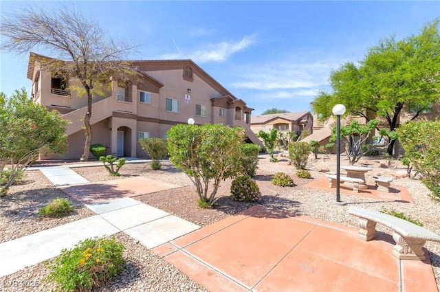 view of front of property featuring a patio and stucco siding
