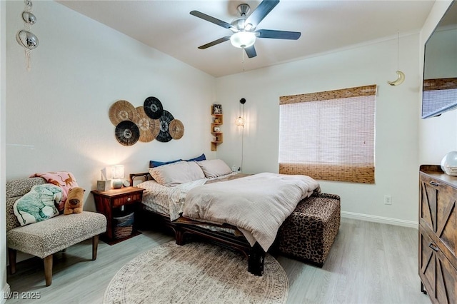 bedroom featuring baseboards, multiple windows, and light wood-style floors