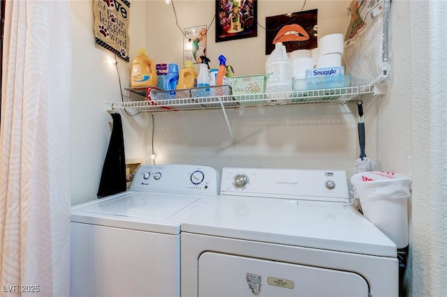laundry area with laundry area, a textured wall, and washer and dryer