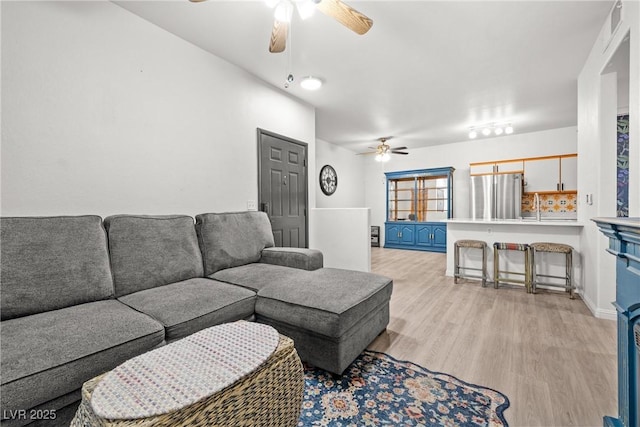 5751 Hacienda Ave Unit 135, Las Vegas, NV 89122 - living room featuring ceiling fan and light wood-style floors