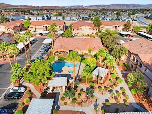 5751 Hacienda Ave Unit 135, Las Vegas, NV 89122 - aerial perspective of suburban area featuring a pool area and a mountainous background