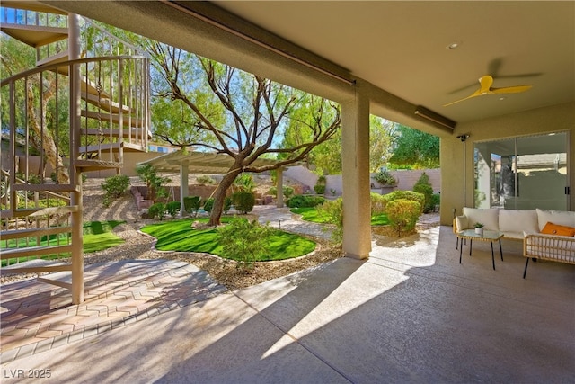 view of patio with an outdoor hangout area, stairway, fence, and a ceiling fan
