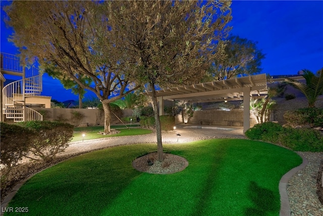 yard at twilight featuring a patio, stairway, a pergola, and a fenced backyard
