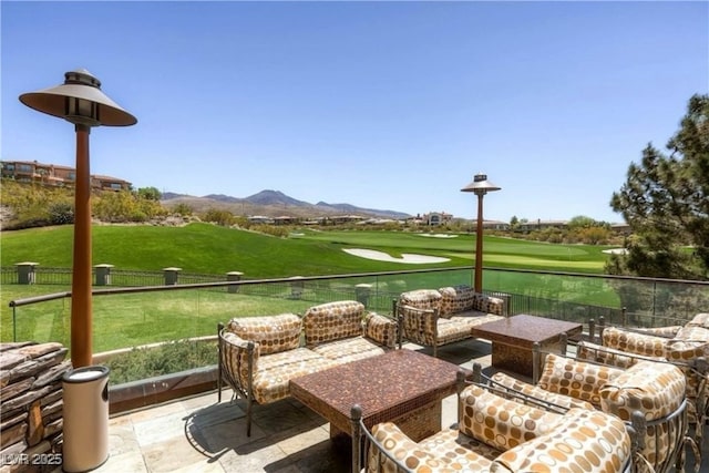 exterior space with an outdoor hangout area, golf course view, and a mountain view