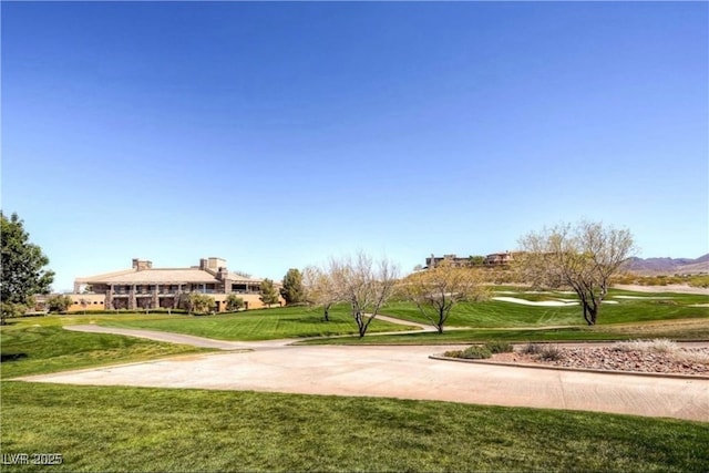 view of home's community featuring a mountain view and a yard