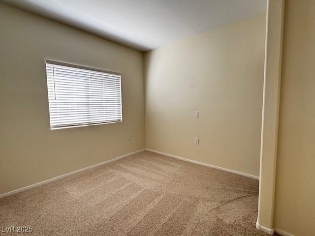 carpeted empty room with baseboards