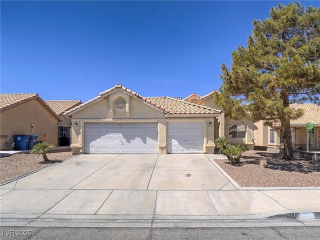218 Pretty Sunset Ter, Henderson, NV 89015 - view of front of property featuring an attached garage, concrete driveway, stucco siding, and a tile roof