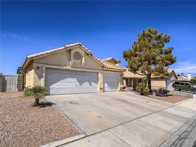 218 Pretty Sunset Ter, Henderson, NV 89015 - mediterranean / spanish-style house with a tiled roof, a garage, fence, stucco siding, and driveway