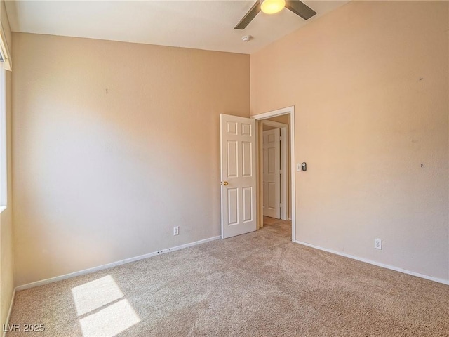 218 Pretty Sunset Ter, Henderson, NV 89015 - empty room featuring ceiling fan, light colored carpet, baseboards, and a high ceiling