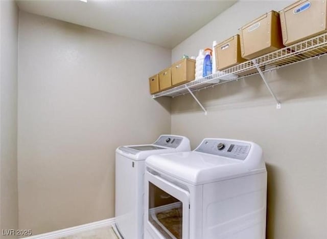 washroom featuring separate washer and dryer, laundry area, and baseboards