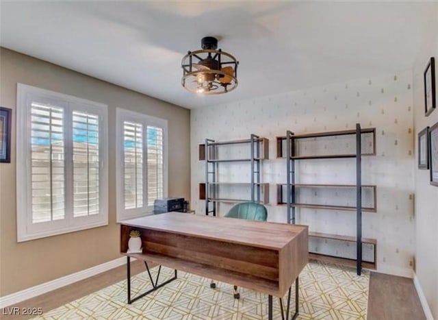 office space featuring wood finished floors, baseboards, and a notable chandelier