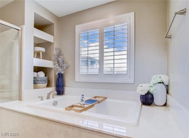 full bathroom featuring a shower with shower door and a bath